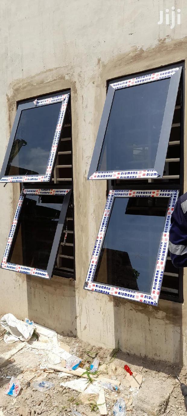 Gray Casement Windows With Dark Glass Well Installed