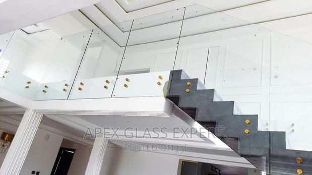 Staircase Glass With Gold Railing Support. photo 2