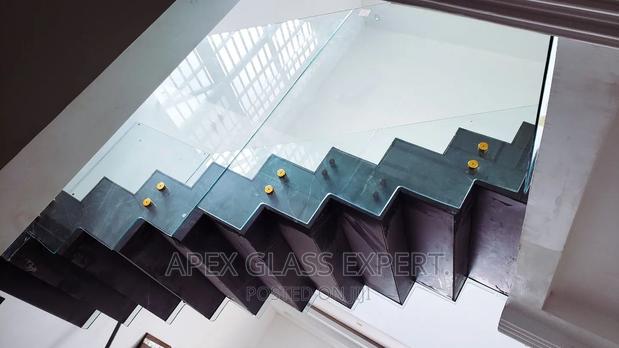 Staircase Glass With Gold Railing Support. photo 3