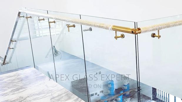 Staircase Glass With Gold Railing Support. photo 4
