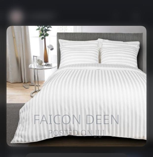 Hotel White Stripped Bed With Pillow Cases · Photo 1