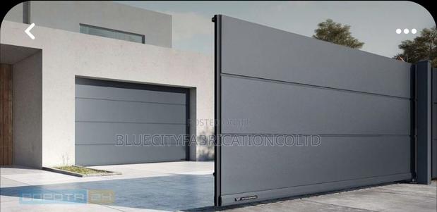 Black Automatic Garage Door With Remotes · Photo 2