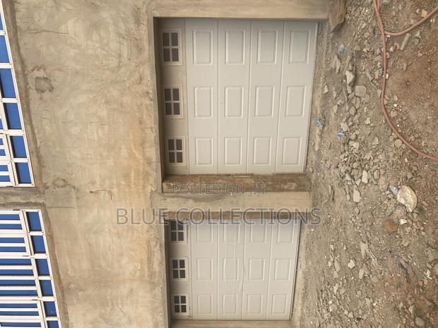Automated Double Garage Door With Fanlight · Photo 2