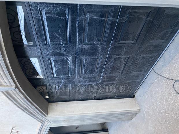 Automated Black Garage Door · Photo 2