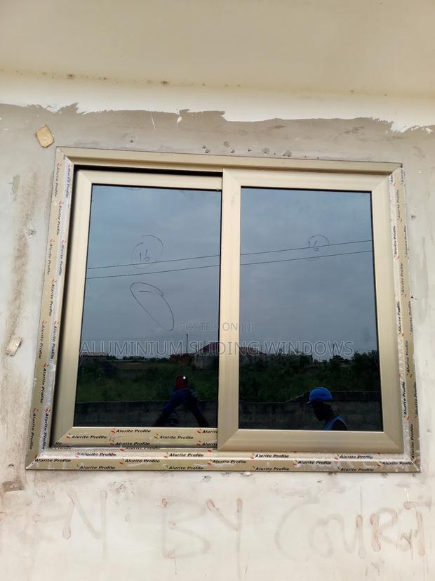 Aluminium Sliding Windows With Dark Tinted Glass and Net