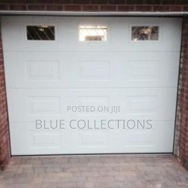 Stylish Automated Garage Door With Fanlight · Photo 2