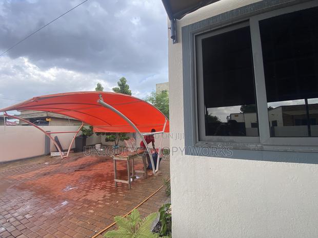 Orange Carport to Match Roofing · Photo 4