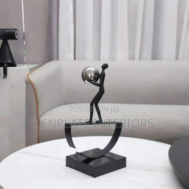 Man Balancing With Ball Sculpture