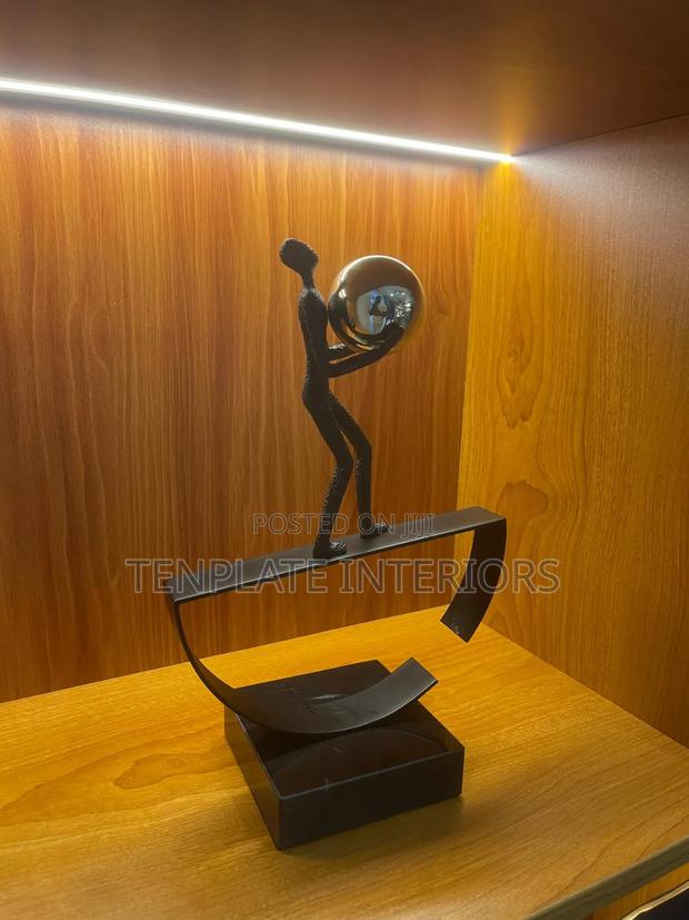 Man Balancing With Ball Sculpture photo 2