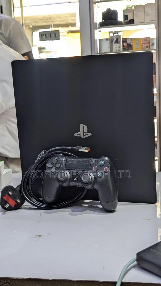 Very Neat Playstation 4 Pro With 15 Games and Accessories Shop Tested. photo 3