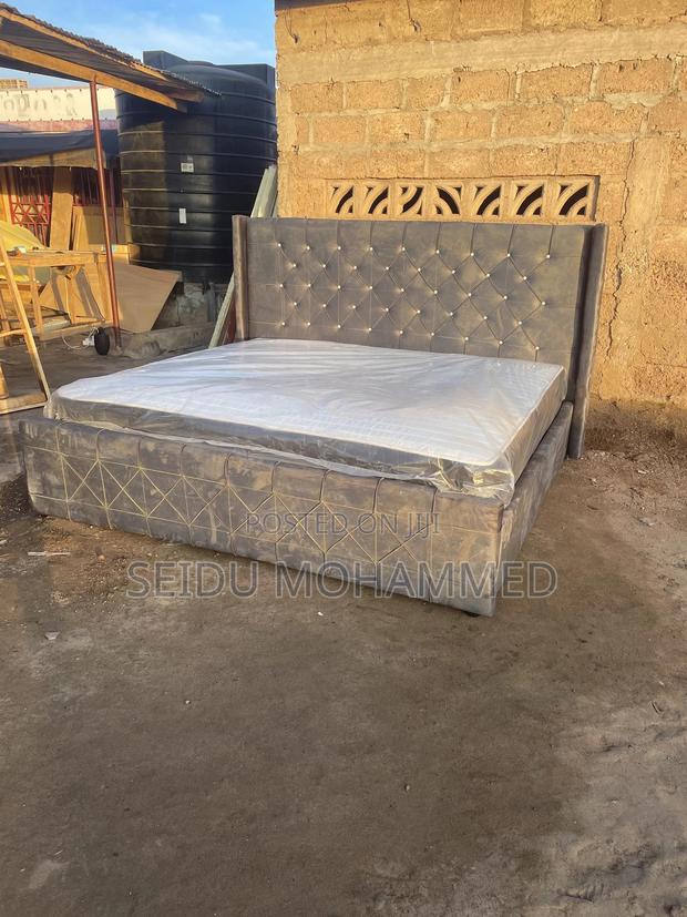 A Kingside Bed Frame With a Mattress · Photo 2