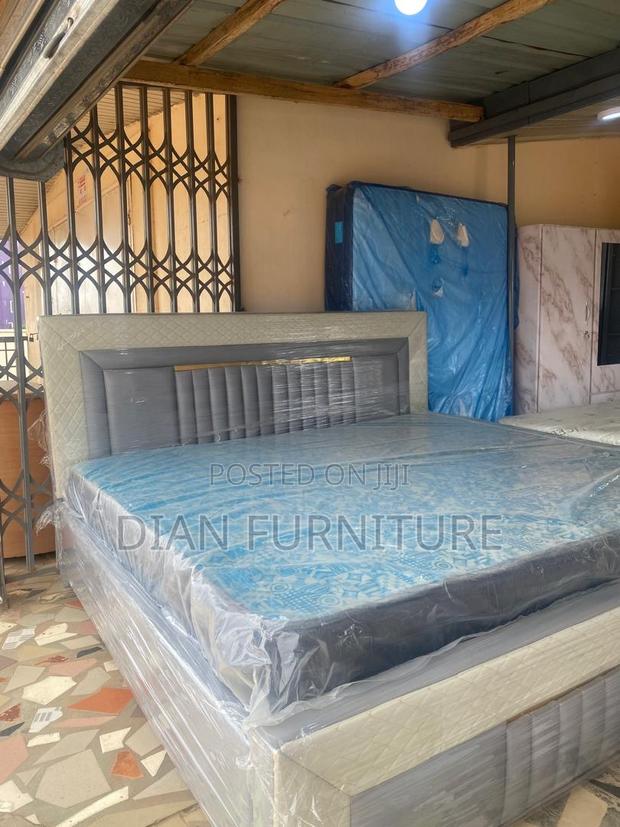 Neatly Made King Size Bed Frame With Mattress Available as Seen