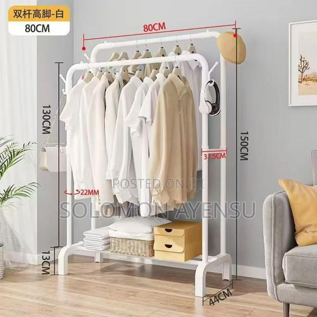 This Shows a Freestanding, Portable Metal Clothing Rack With Shelves.