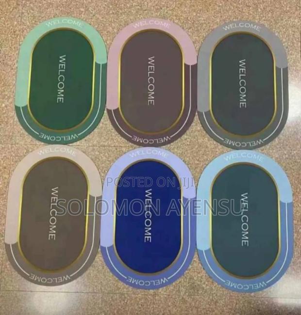 Super Absorbent Welcome Mat With a Gold-Colored Trim.