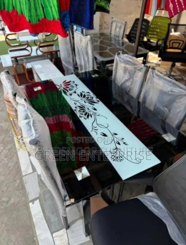 Elegant Black Dining Table With Floral Accent and Chairs